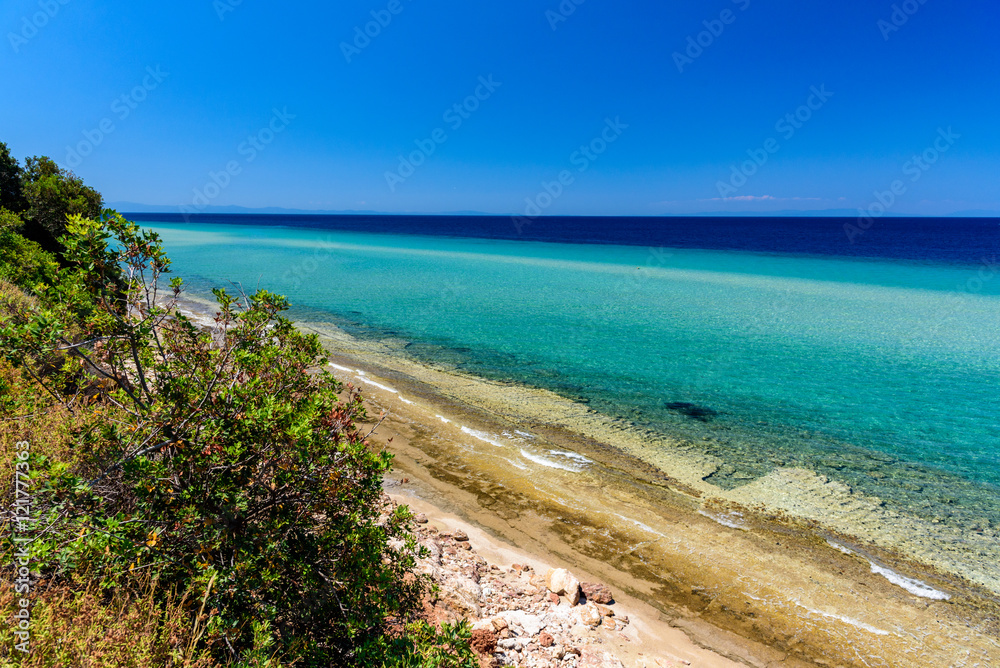 Beautiful beach on Thassos island, Greece - turquoise crystal clear waters and soft sand, clear sky - perfect vacation destination