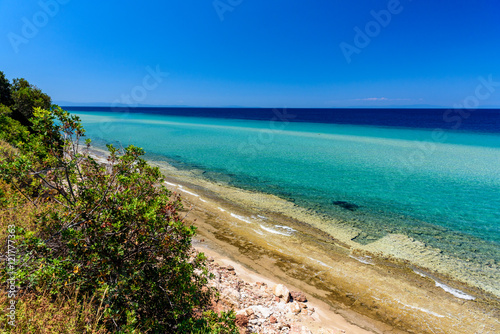 Beautiful beach on Thassos island  Greece - turquoise crystal clear waters and soft sand  clear sky - perfect vacation destination