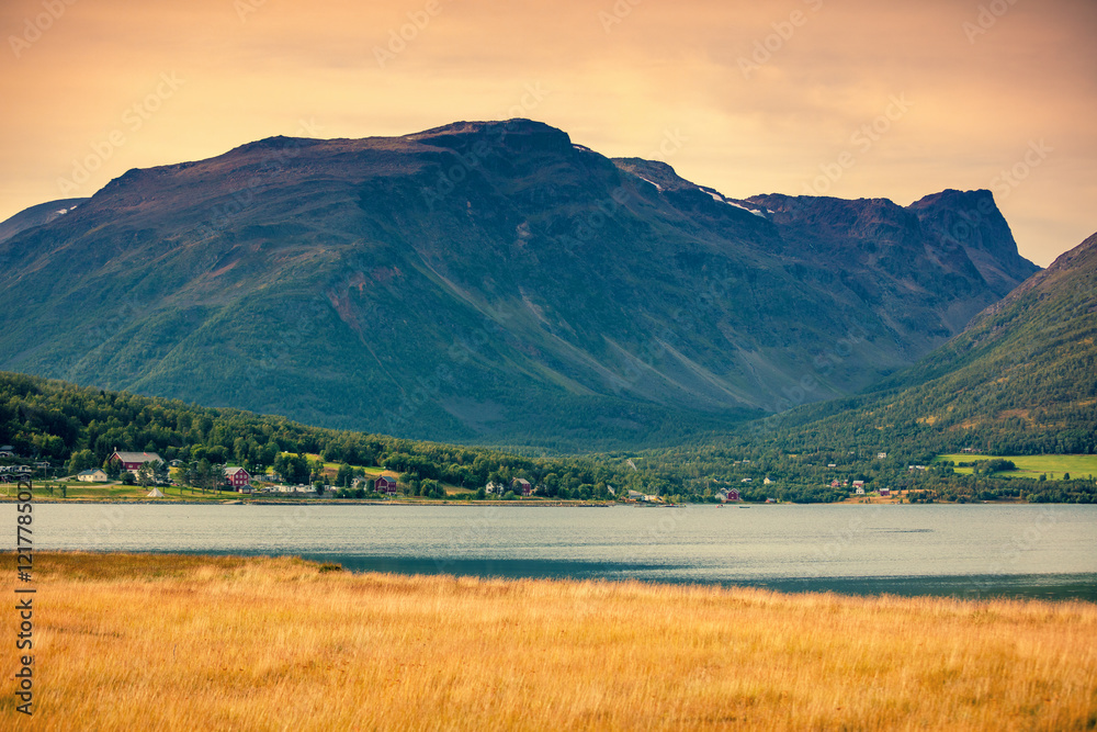 Fototapeta premium The village in a mountain valley is near the fjord