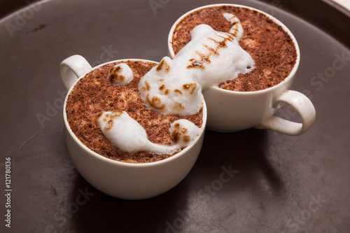 Coffee with foam in the form of cat and mouse