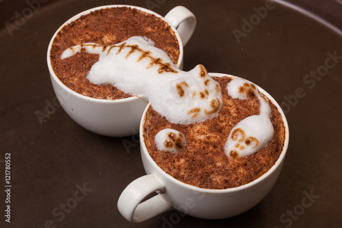 Coffee with foam in the form of cat and mouse