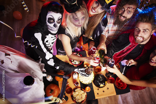 Photography Halloween party over big and spooky table.