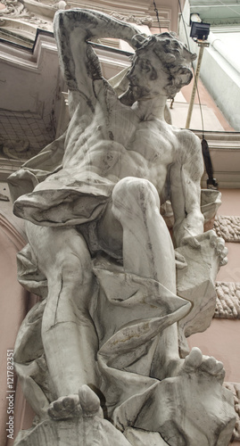 Fotografie male figure sculpture on the facade of an old house in Art Nouveau style