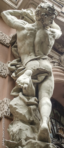 Canvas-taulu male figure sculpture on the facade of an old house in Art Nouveau style