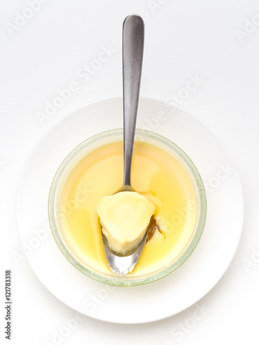 Obraz na płótnie spoon overhead shot takes a piece of homemade custard, isolated