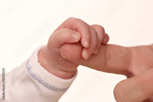 hand of a baby holding the hand of his mother