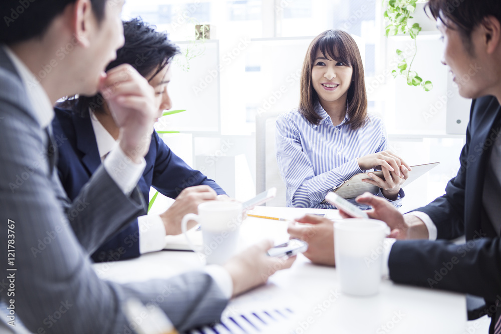 Four businessmen working in bright office Four businessmen working in bright office