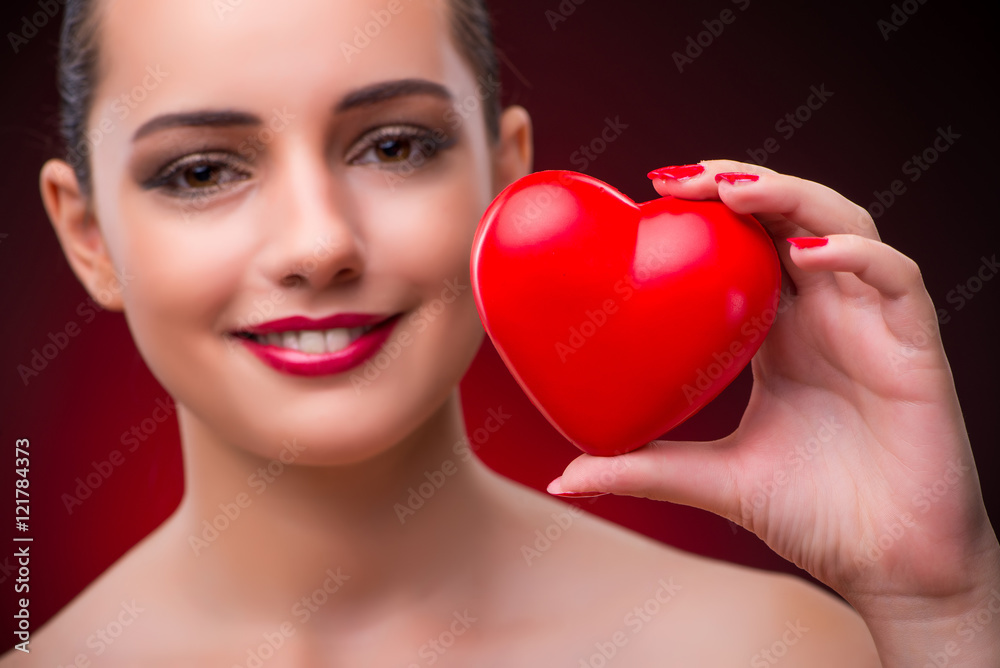 Woman with red heart in romantic concept Woman with red heart in romantic concept