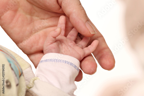 hand of a baby holding the hand of his mother