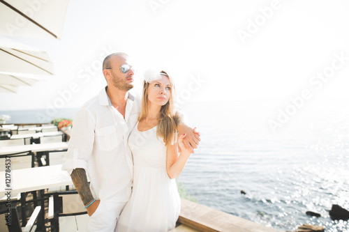 happy just married young wedding couple celebrating and have fun at beautiful beach sunset