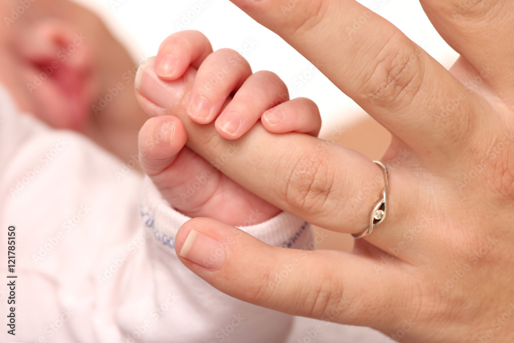 hand of a newborn baby holding her mother hand hand of a newborn baby holding her mother hand