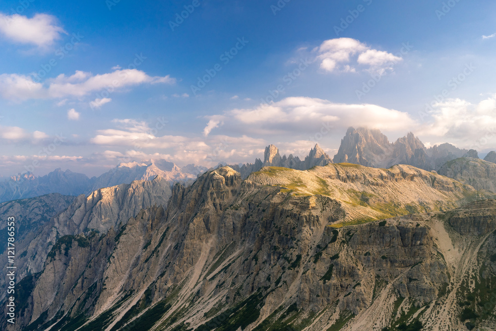 Obraz premium Horizontal view of dramatic mountains landscape. Photo of summer landscape in Italian Dolomites. Beautiful evening golden light. UNESCO World Heritage Site.