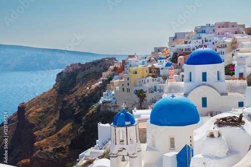 Fototapeta Naklejka Na Ścianę i Meble -  Oia, traditional greek village of Santorini with blue domes of churches, Greece