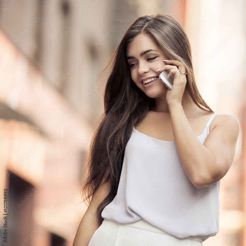 Young Beautiful Woman Talking On Mobile Phone. Young Beautiful Woman Talking On Mobile Phone.