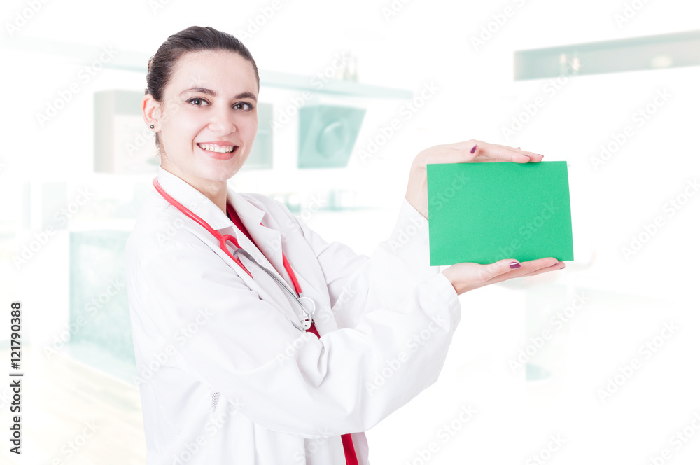 Happy beautiful surgeon holding empty paper Happy beautiful surgeon holding empty paper