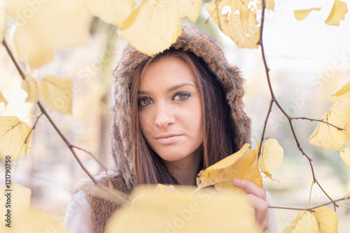 Beautiful young woman among autumn leaves, autumn lifestyle concept. photo