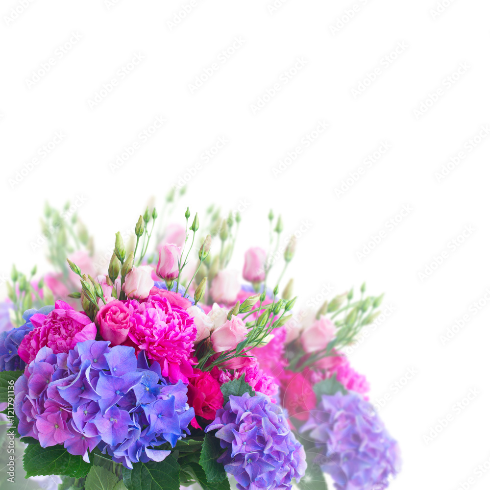 Bright pink peony, eustoma and blue hortensia flowers bouquet close up over white background