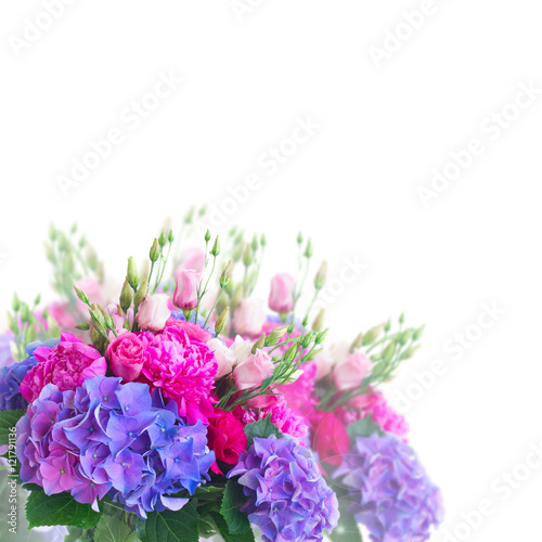 Bright pink peony  eustoma and blue hortensia flowers bouquet close up over white background