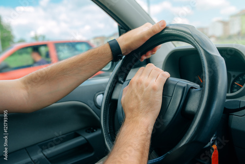 Nervous male driver pushing car horn in traffic rush hour