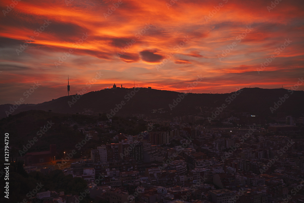 Dramatic shot of Barcelona skyline and downtown under sunset sky