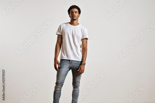 Full-body shot of an athletic attractive young male in ripped light blue jeans and blank white shortsleeve t-shirt