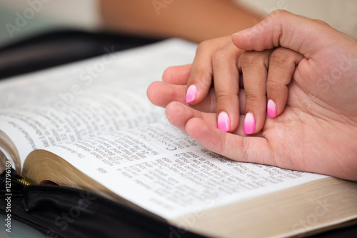 Couple with hands on the Bible