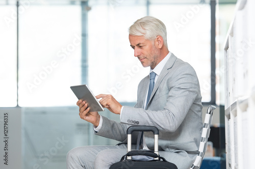 Businessman using tablet at airport