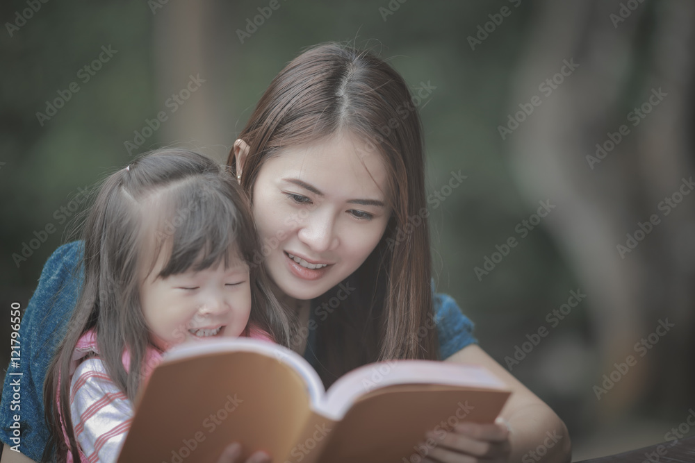 young mother reading a book to her cute daughter vintage style young mother reading a book to her cute daughter vintage style