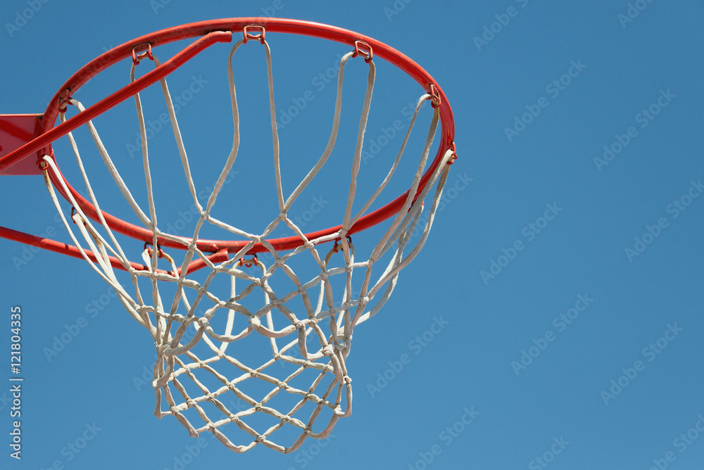 Basketball hoop with blue sky background