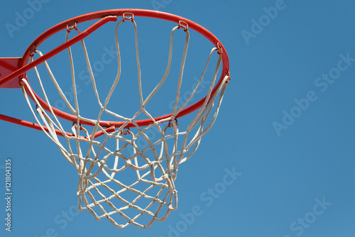Basketball hoop with blue sky background