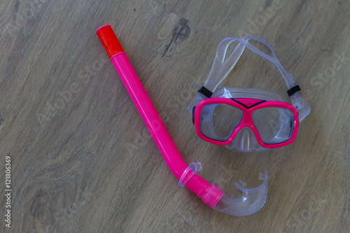 scuba diving snorkel mask and tube on wooden background