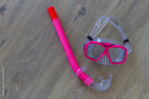 scuba diving snorkel mask and tube on wooden background