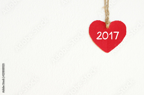 Red fabric heart with 2017 word white wall background