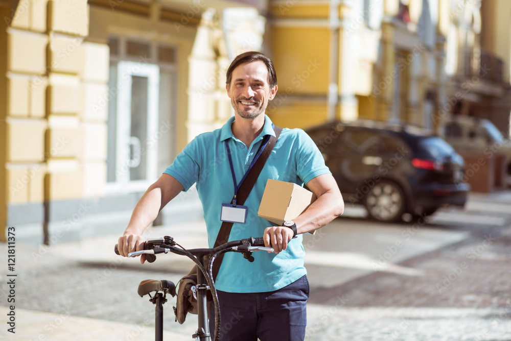 Fototapeta premium Positive man holding a box