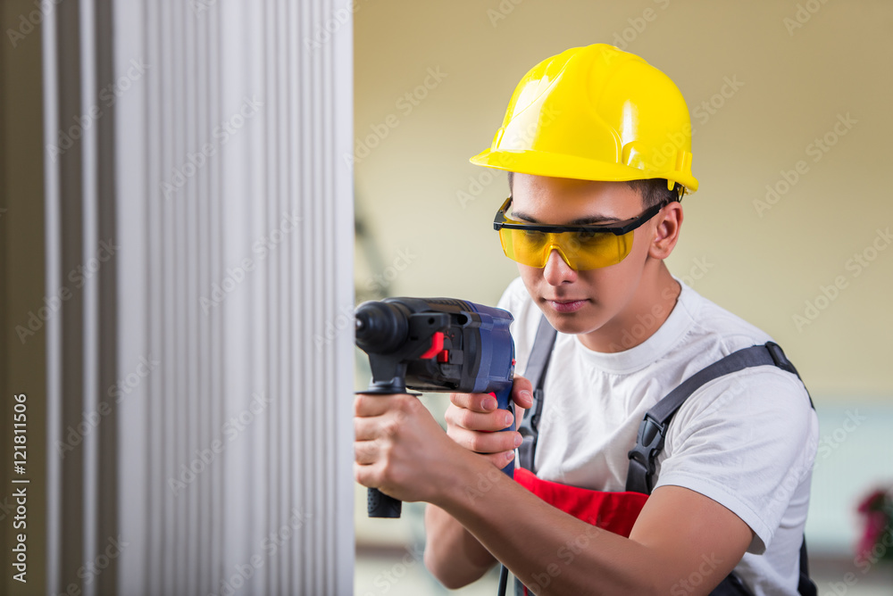 Man drilling the wall with drill perforator Man drilling the wall with drill perforator