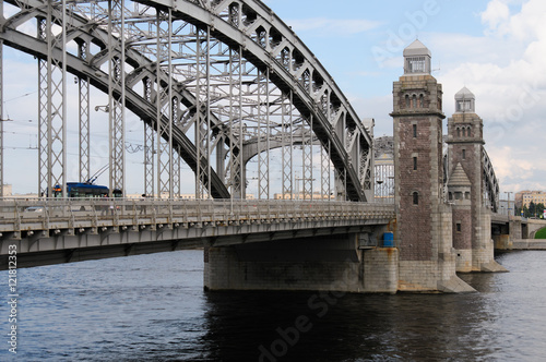 Historic bridge of Emperor Peter the Great over river Neva in Saint-Petersburg,  later name - Bolsheohtinsky. Three-span metal bridge, central part is adjustable. Towers - govern divorce of bridge.  photo