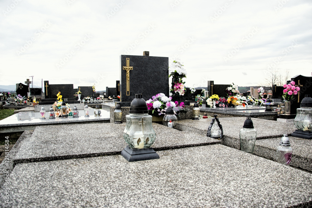 Graves, tombstones and crucifixes on traditional cemetery. Votive