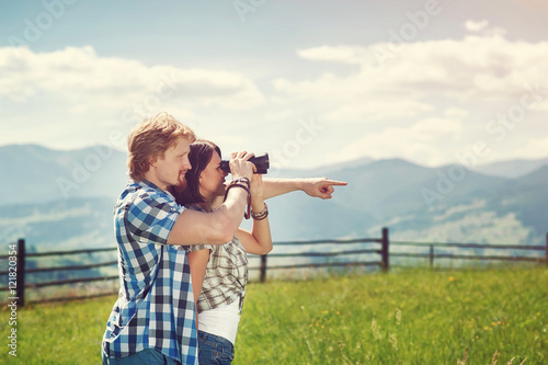 couple of man and woman looking through binoculars finding new way