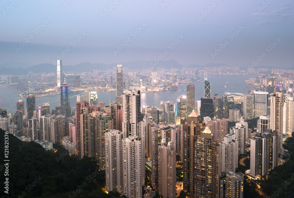 Fototapeta premium Skyscrapers of Hong Kong in China, Asia. Night view of the city life. Light of the buildings are very colorful, shining with warm tones.