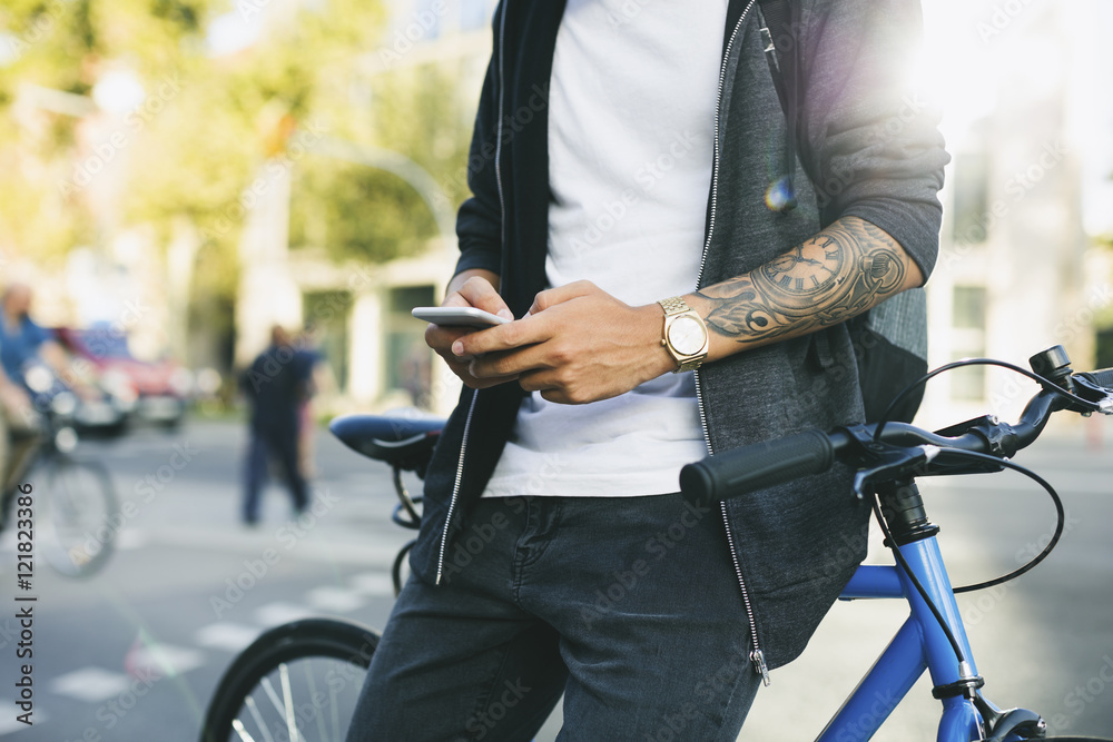 Teenager with a fixie bike, using smartphone Teenager with a fixie bike, using smartphone