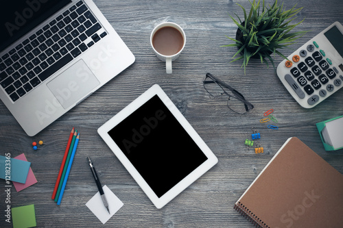 Laptop and tablet on wooden desk