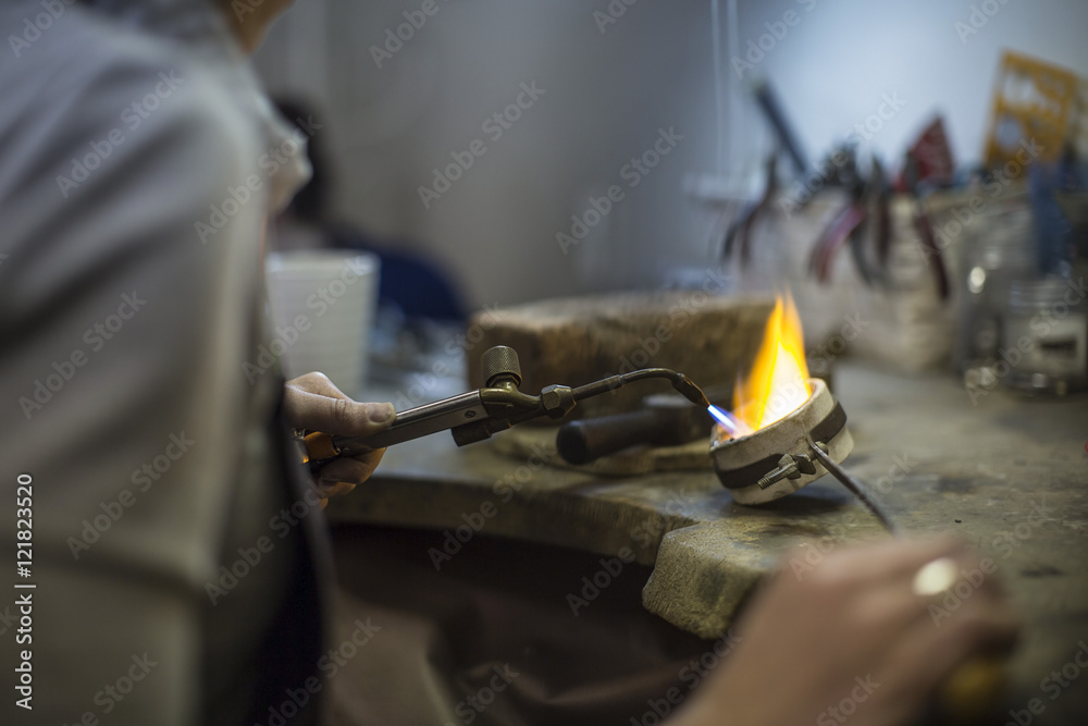 Goldsmith working with blow torch Goldsmith working with blow torch