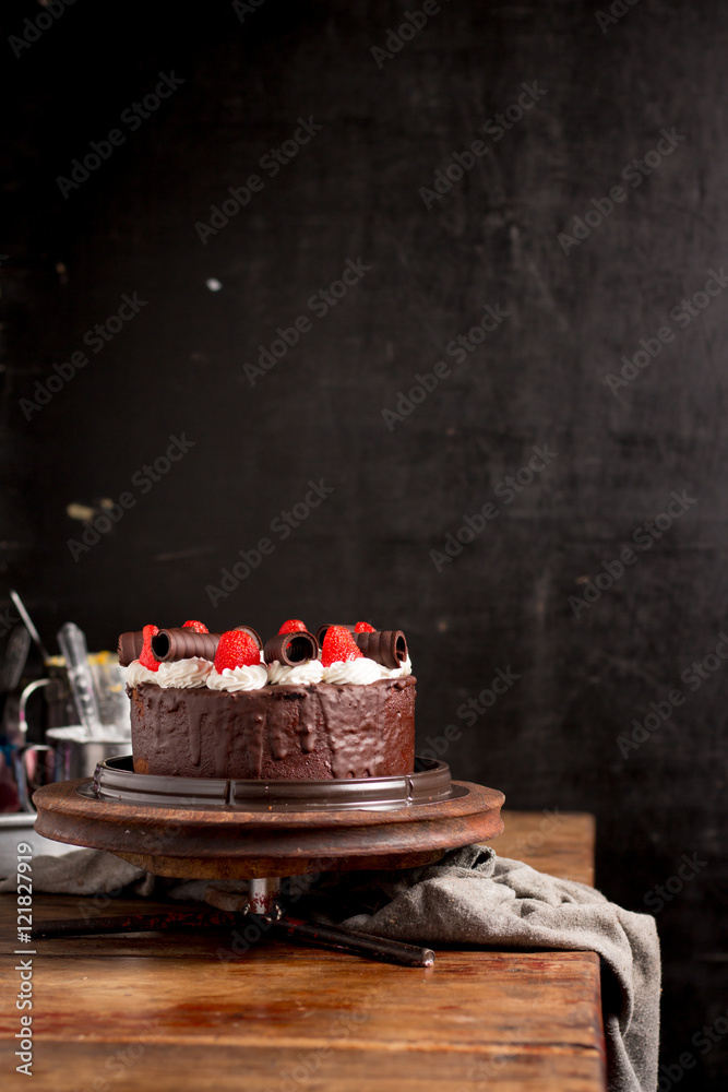 Strawberry Chocolate Cake on vintage wooden background. Dark foo