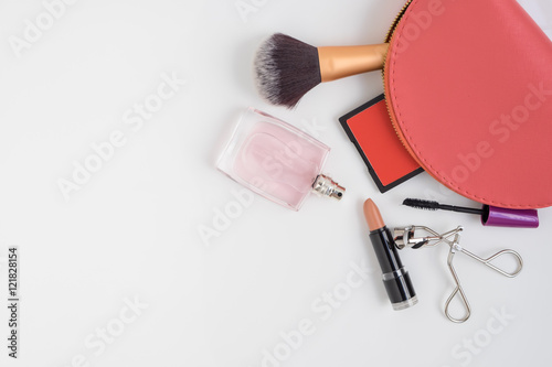 Top view of pink cosmetic bag and make up products