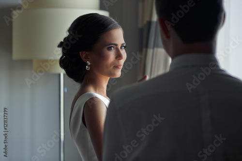 The charming bride looks at her groom