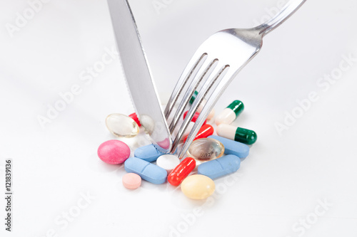 Drugs, medicine in a dish with fork and knife