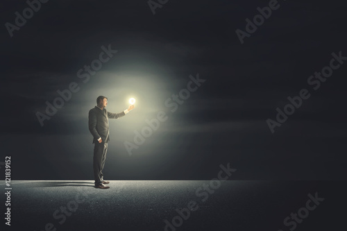 Leader Man with bulb walking illuminating his path
