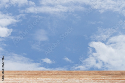 cloud and blue sky in daylight with wood table