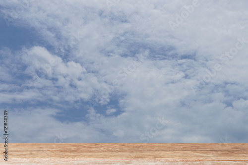 cloud and blue sky in daylight with wood table