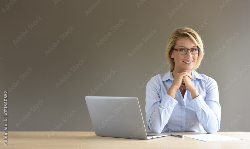 Portrait of businesswoman using laptop, isolated Portrait of businesswoman using laptop, isolated